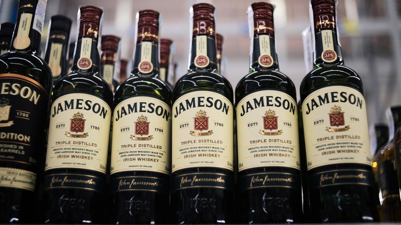 A row of Jameson whiskey bottles on a store shelf