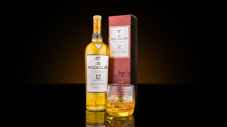 A bottle of 12-year-old Macallan next to a glass of whiskey
