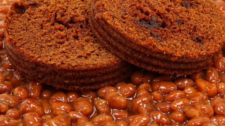 slices of boston brown bread from a can, served over baked beans