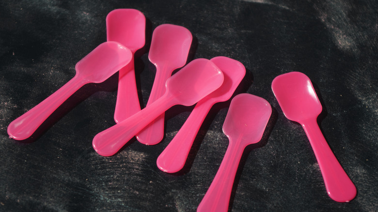 Ice cream sample spoons on a black table
