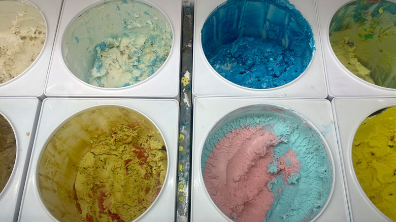 A display with several ice cream flavors that appear grainy