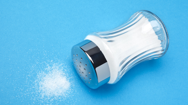 Salt shaker on blue background