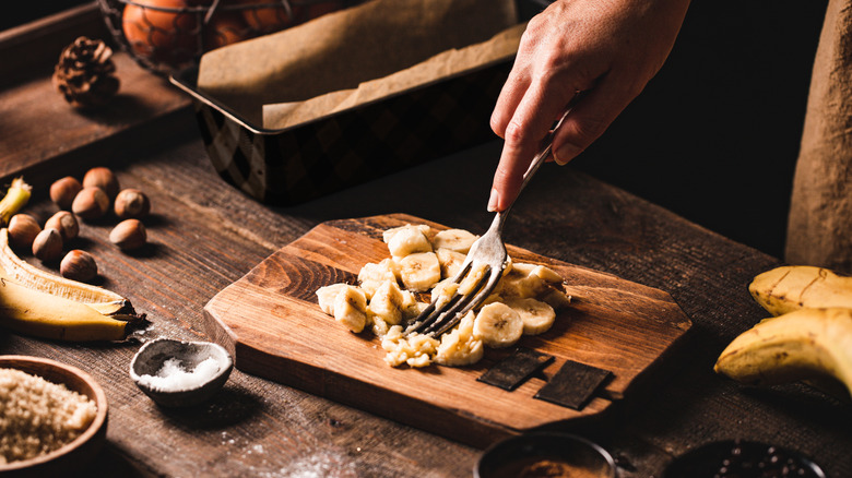 person mashing banana