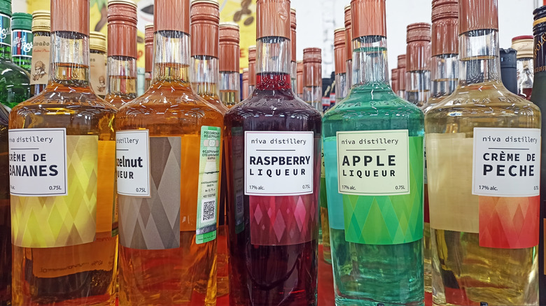 A variety of liqueur bottles on a shelf