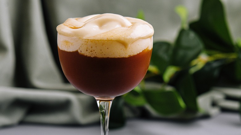 An espresso martini topped with extra creamy foam
