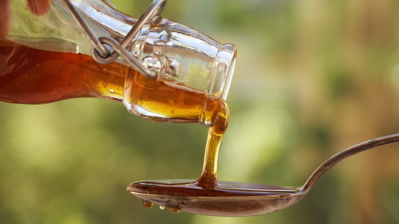 Close up of golden syrup being poured onto a spoon