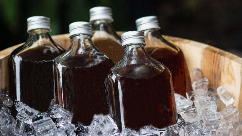Four bottles of cold brew coffee concentrate in an ice bucket