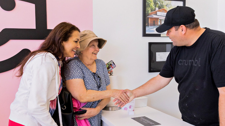 Crumbl employee shaking hands