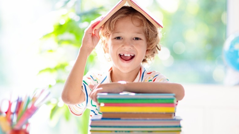 little boy with books