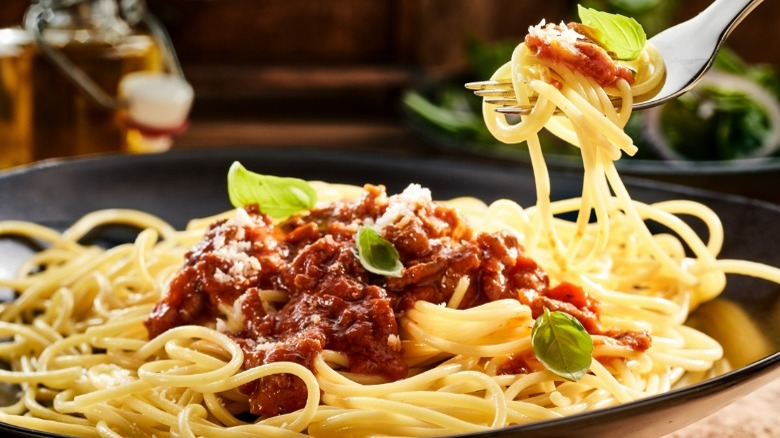 Fork lifting spaghetti and red sauce