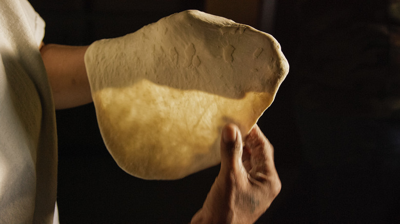 person making a tortilla