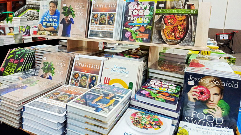 Many cookbooks lined up in a store display