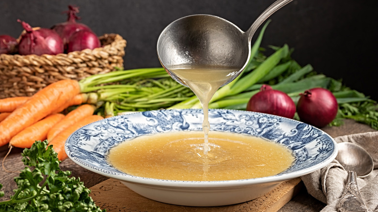 Homemade chicken broth in bowl