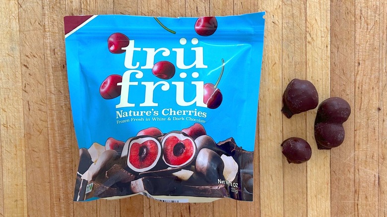 Package and pieces of Nature's Cherries Hyper-Chilled in White and Dark Chocolate