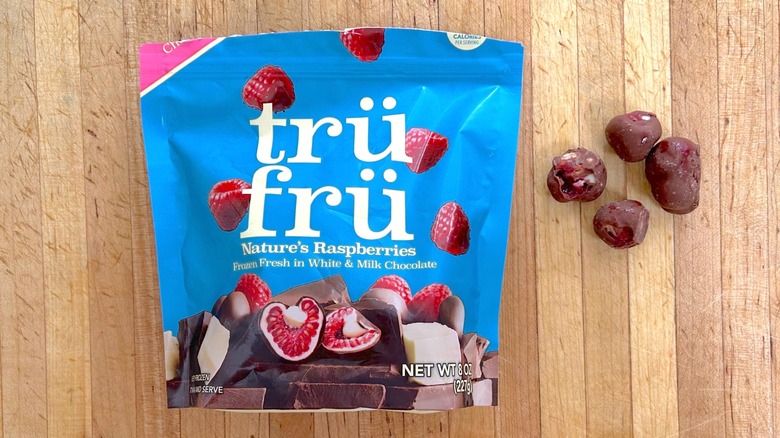 Package and pieces of Nature's Raspberries Hyper-Chilled in White and Milk Chocolate