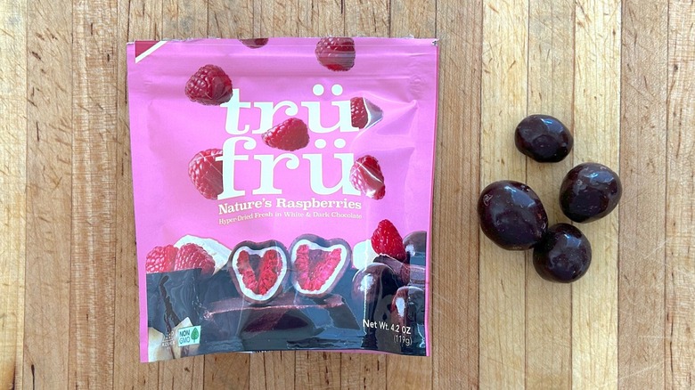 Package and pieces of Nature's Raspberries Hyper-Dried in Dark and White Chocolate
