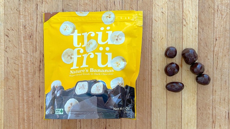 Package and pieces of Nature's Bananas Hyper-Dried in Dark Chocolate