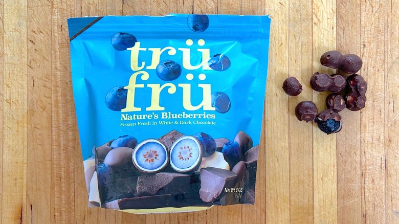 Package and pieces of Nature's Blueberries Hyper-Chilled in White and Dark Chocolate