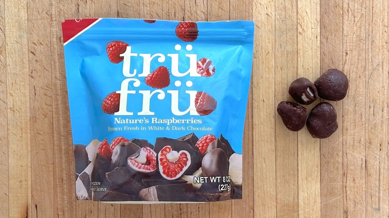 Package and pieces of Nature's Raspberries Hyper-Chilled in White and Dark Chocolate