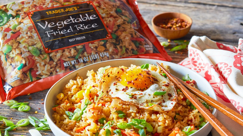 trader joe's vegetable fried rice served topped with fried egg, alongside package