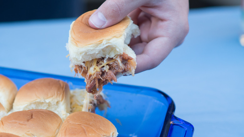 Person grabbing a slider sandwich