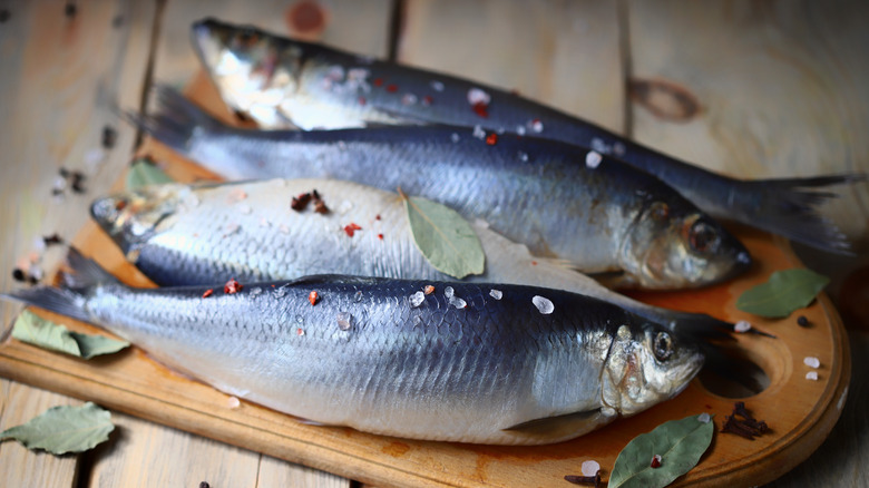 Fresh herring on wooden board