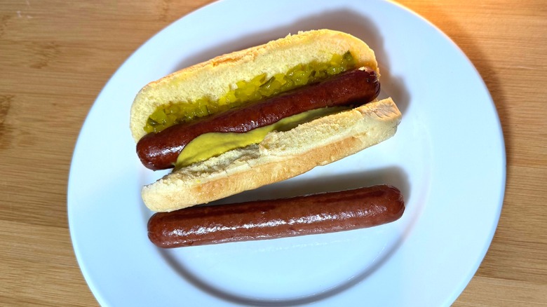 Brown and crispy air-fried hot dogs, plain and in a bun with relish and mustard.