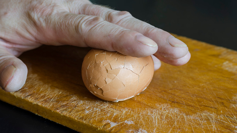 person rolling egg on board