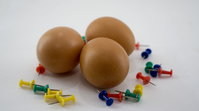 eggs and colored thumbtacks