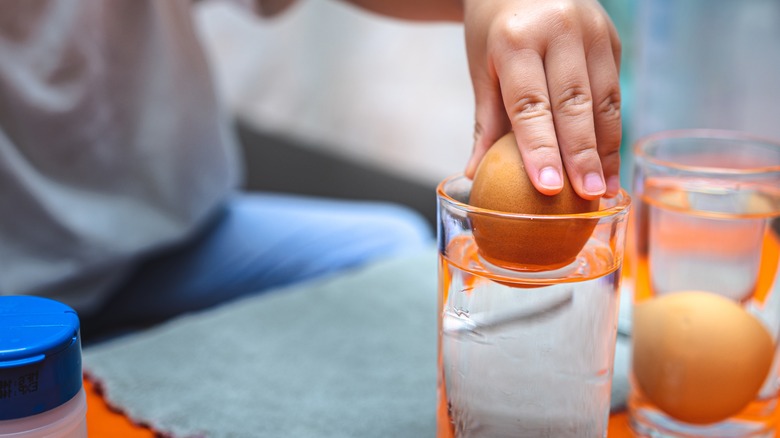 submerging eggs in water glass