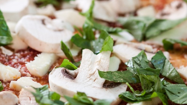 mushrooms and basil on pizza