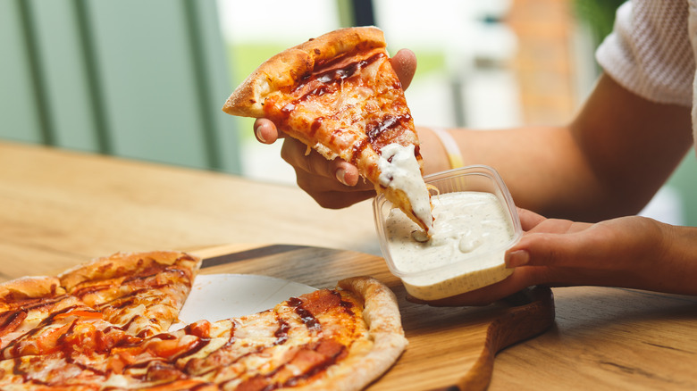 dipping pizza in sauce