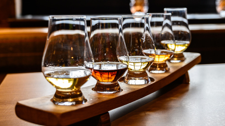 Closeup of a flight of whiskeys on a board