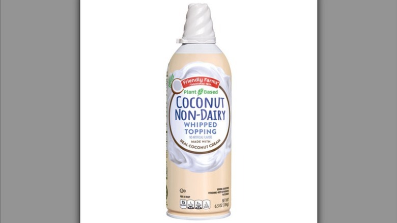 a bottle of coconut non-dairy whipped topping with a white cover over the nozzle against a white background.