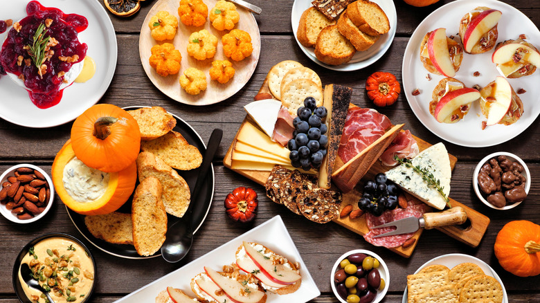 Charcuterie board and fall-themed appetizers on table