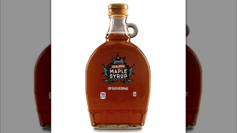 a bottle of 100% Pure Maple Syrup against a white background.