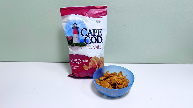 A bowl of chips next to a bag of Cape Cod Kettle Cooked BBQ Chips