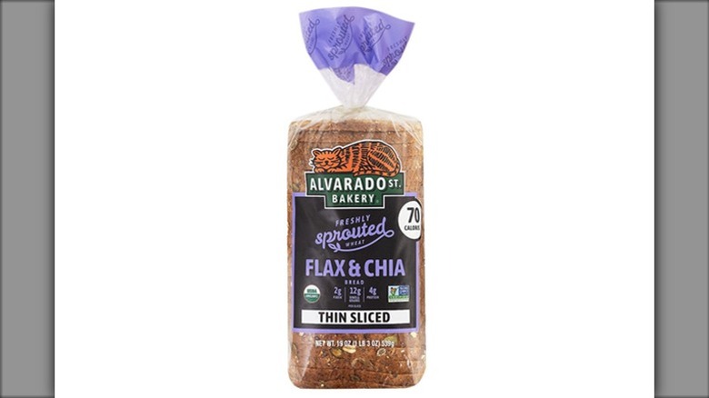 a loaf of Alvarado Street Bakery Sprouted Flax & Chia bread in its packaging against a white background.