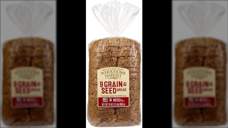 a loaf of Wholesome Harvest 9 Grain & Seed Bread in its packaging against a white background