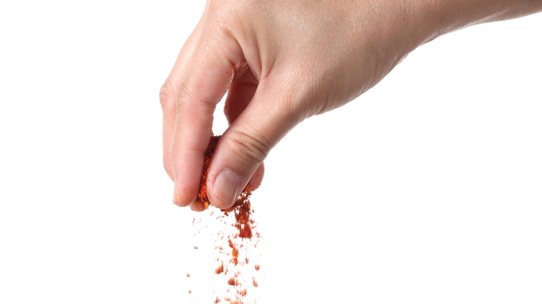 Person sprinkling spices