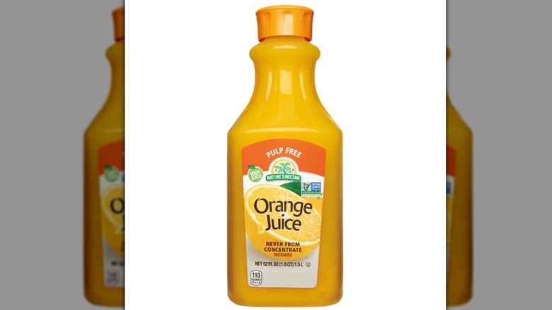 A bottle of Nature's Nectar Orange Juice on a white background