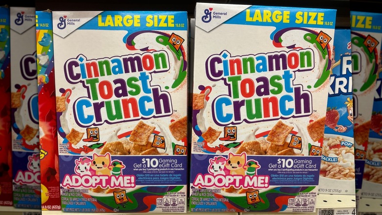 Two boxes of Cinnamon Toast Crunch cereal on a shelf