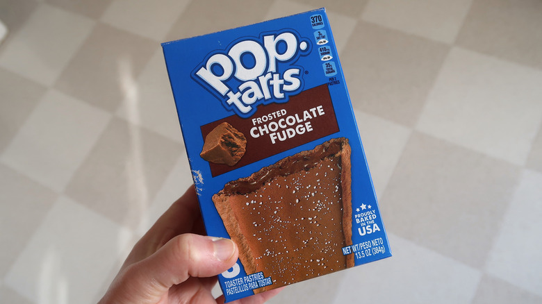 Person holding a box of Chocolate Fudge Pop-Tarts