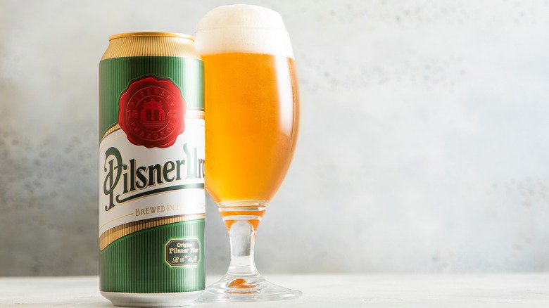 A can and glass of Pilsner Urquell beer