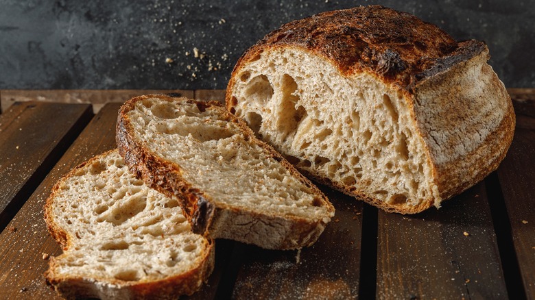 Close up of a homemade loaf of sourdough bread on a cutting board