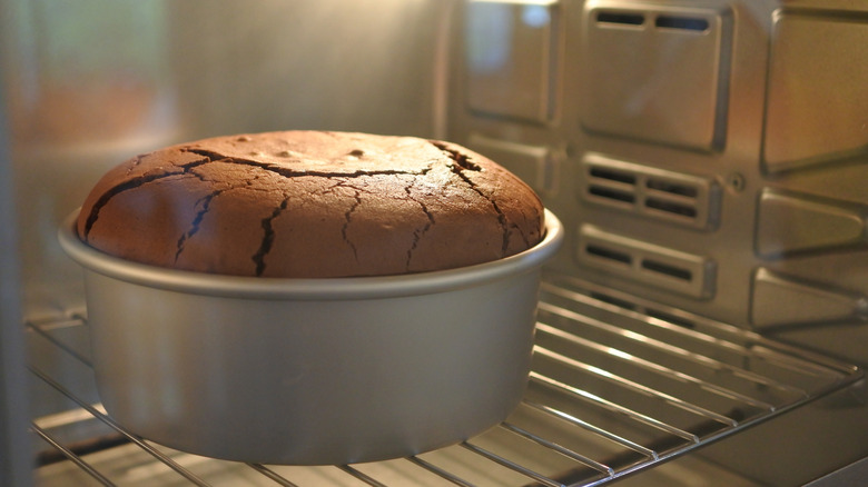 A chocolate cake baking in an oven