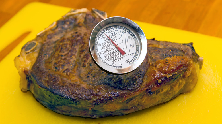 Testing a cooked steak with a meat thermometer