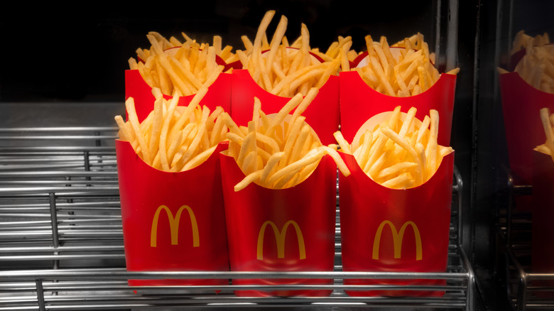 a group of six orders of McDonald's fries in their red containers