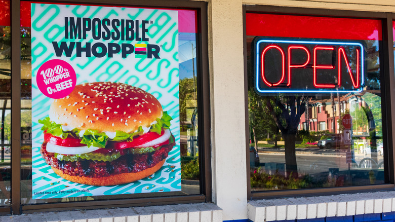 image of the exterior of a Burger King with a window banner advertising the Impossible Whopper