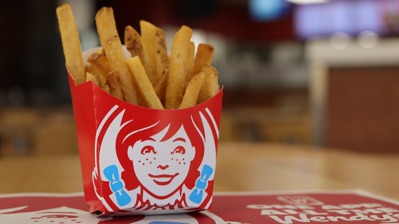 An order of Wendy's fries sitting in a red Wendy's fry basket